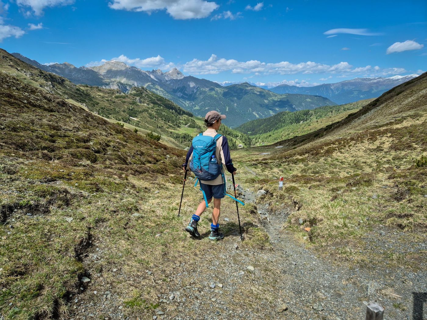 A hiker descending into a valley near Obernberg am Brenner in the state of Tyrol, Austria- supplied by Eurohike