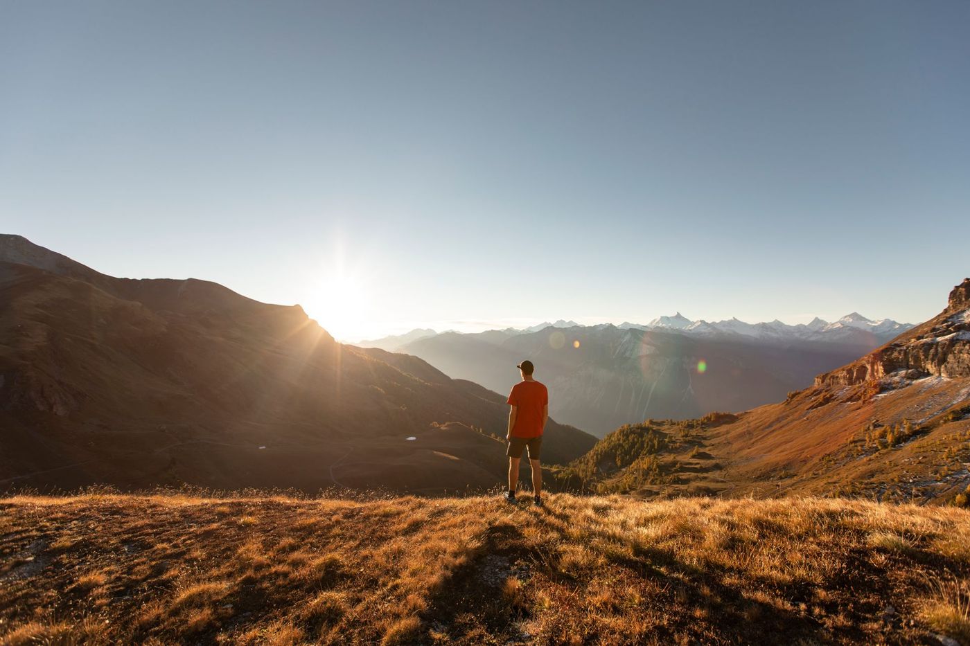 Hiker standing on a golden alpine meadownear Crans-Montana in the Valais canton of Switzerland-supplied by Eurotrek