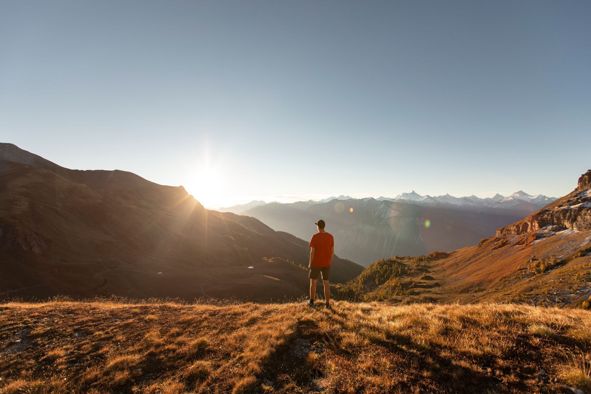Hiker standing on a golden alpine meadownear Crans-Montana in the Valais canton of Switzerland-supplied by Eurotrek