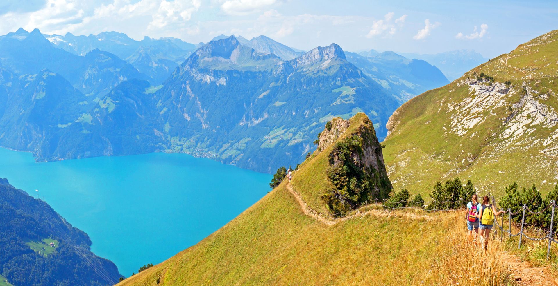 Hikers following a scenic ridge trail between Klingenstock and Fronalpstock near Stoos, Switzerland
