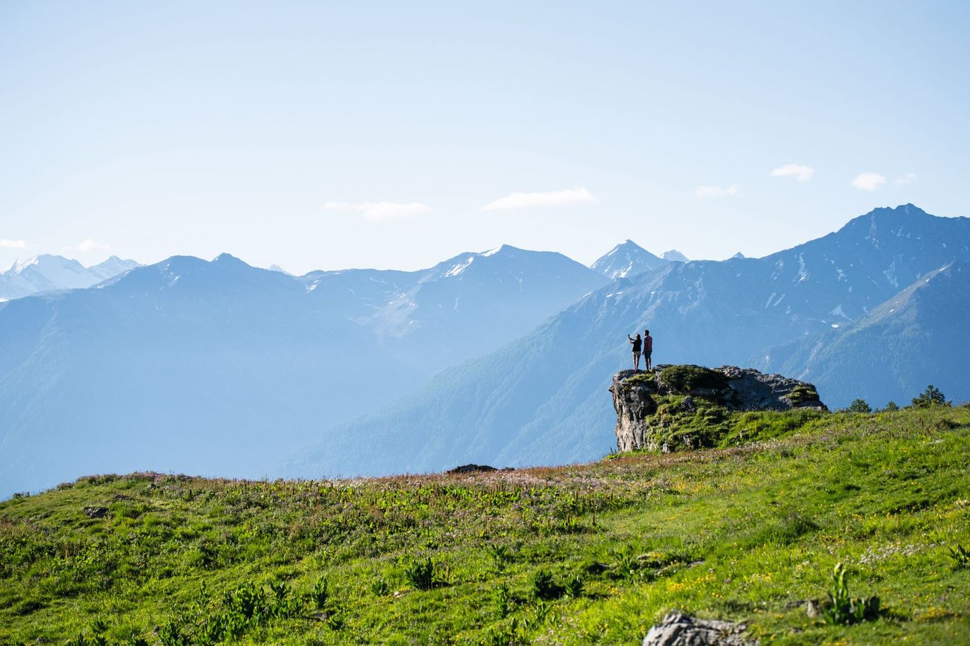 Hikers on a lush green meadow along the Wildstrubel circuit trail in the Valais region of Switzerland-supplied by Eurotrek